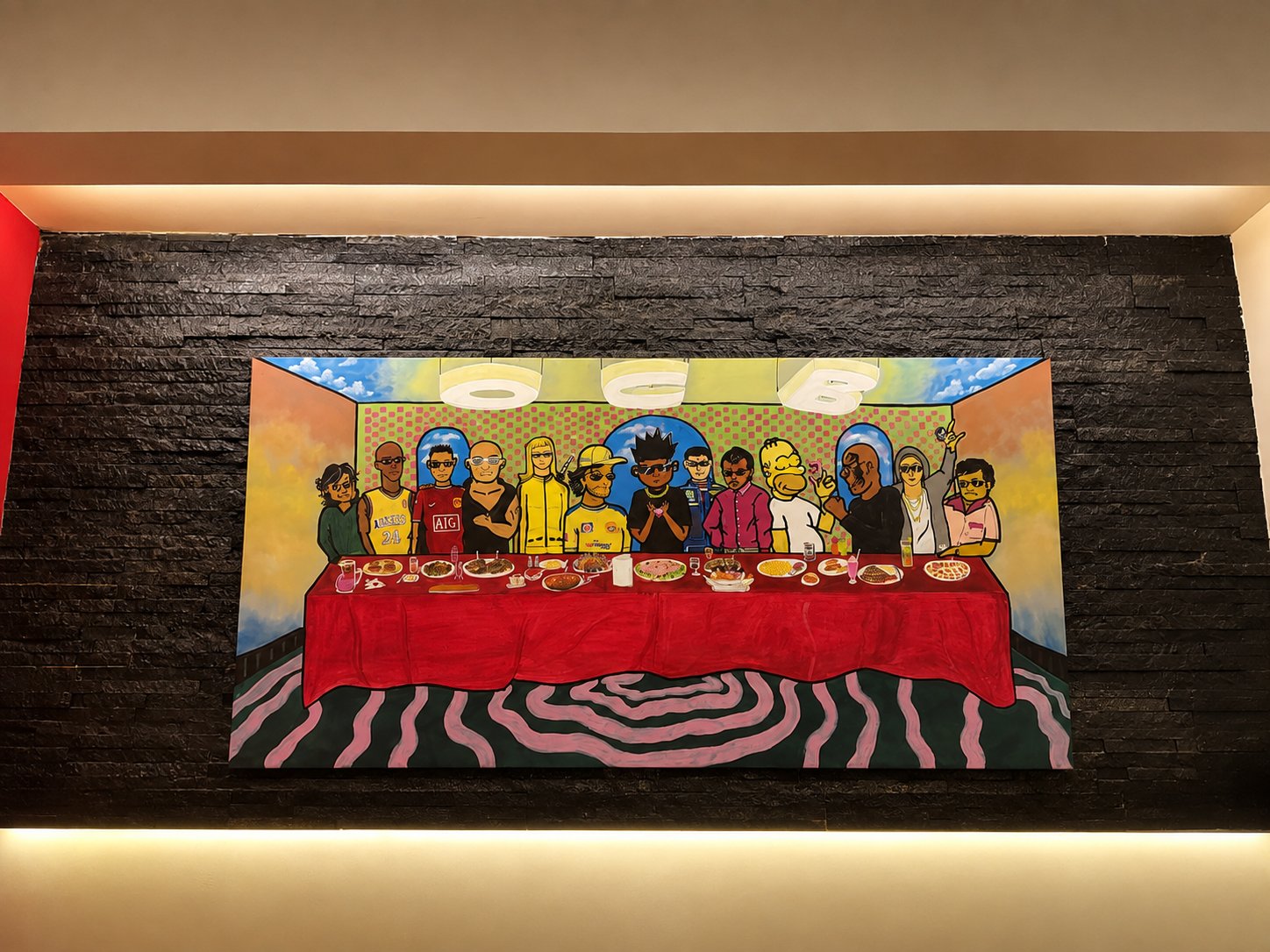 OCB mural artwork on the bunker wall, a playful pop-culture last supper scene